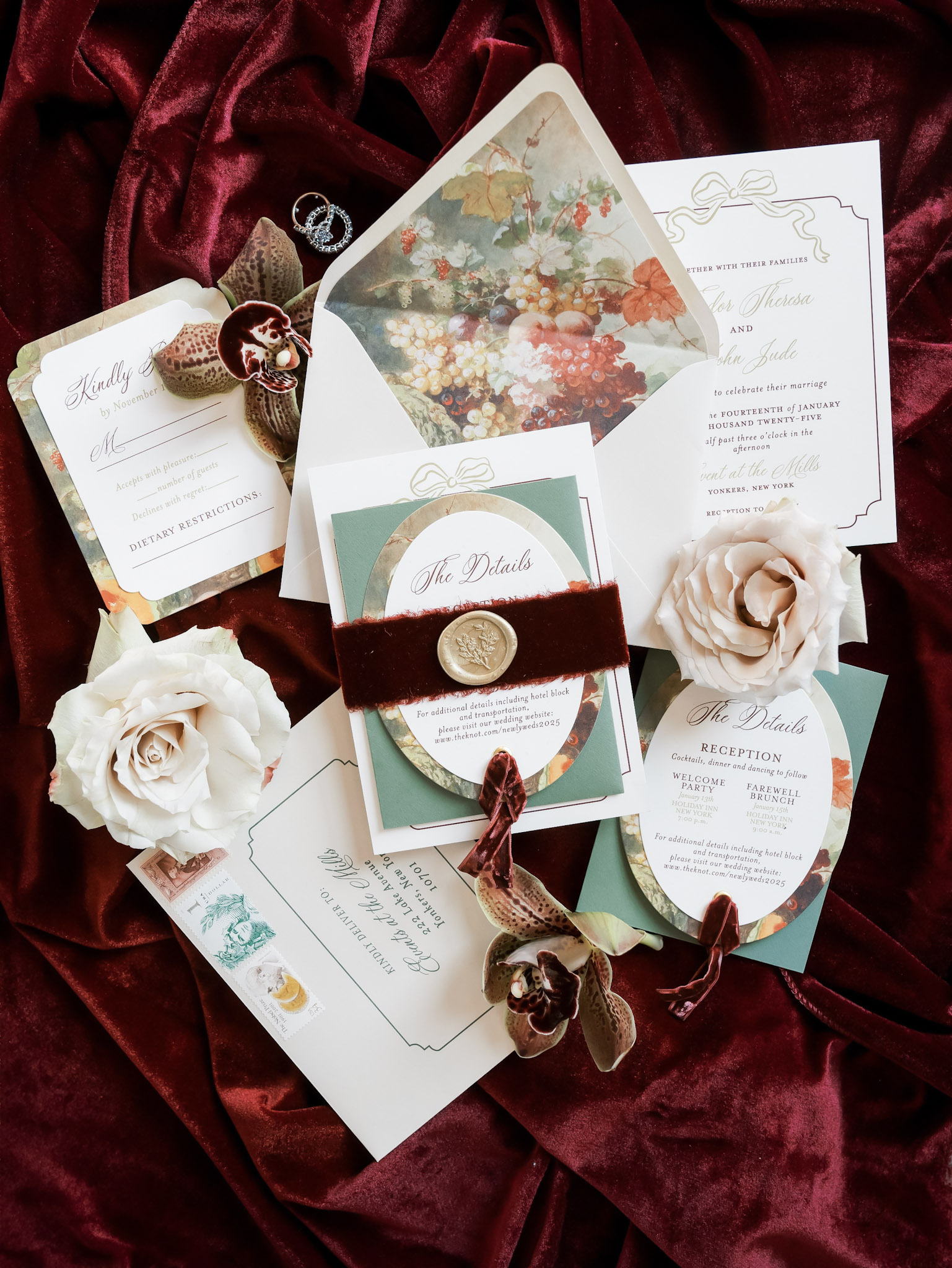 Elegant wedding invitation suite with wax seals, burgundy velvet ribbons, and floral envelope lining on rich burgundy velvet background