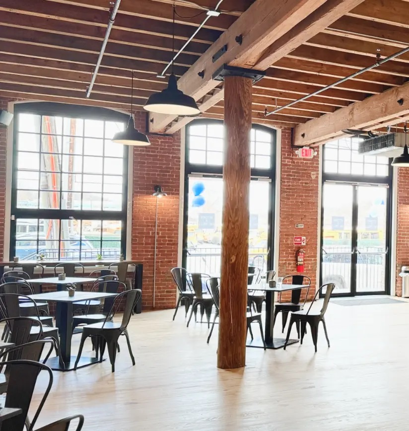 Kitchen at the Mills space with industrial windows and modern seating